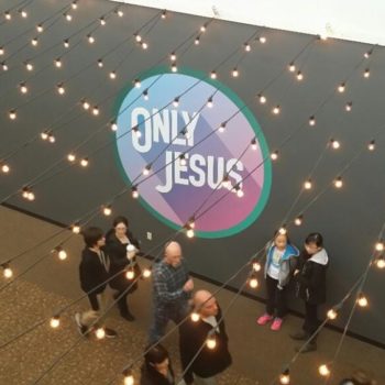 Only Jesus wall mural with people walking by