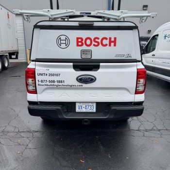 White Ford Ranger truck with custom vehicle wrap and logo graphics parked in Raleigh, NC.