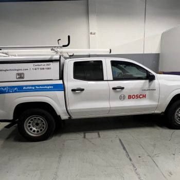 White pickup truck with partial vehicle wrap and vinyl decals in Raleigh, NC.