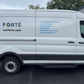 White cargo van with partial vehicle wrap graphics on the side panel in Raleigh, NC.