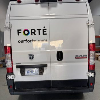 Rear view of white RAM ProMaster van with partial vehicle wrap lettering in Raleigh, NC.