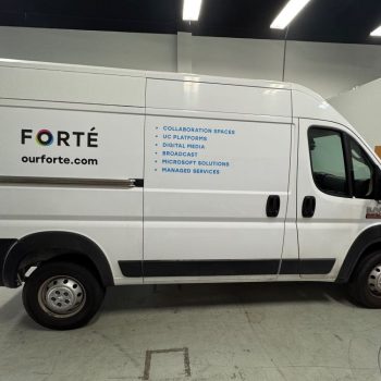 White commercial van with partial vehicle wrap signage in black and blue text in Raleigh, NC.