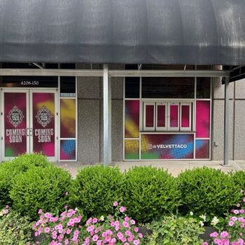Colorful window film graphics on storefront doors and windows with black awning in Raleigh, NC.