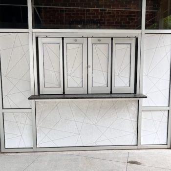 Frosted geometric window film applied on service window and surrounding glass in Raleigh, NC.