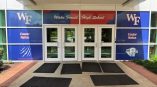 Window film graphics with school logos and colors on entrance doors in Raleigh, NC.