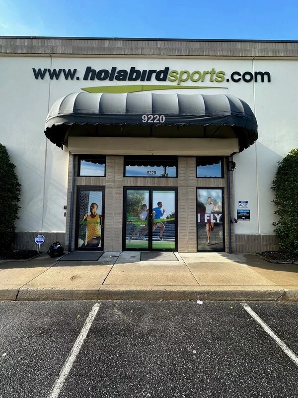 Custom storefront signage and branded awning installed on a retail building