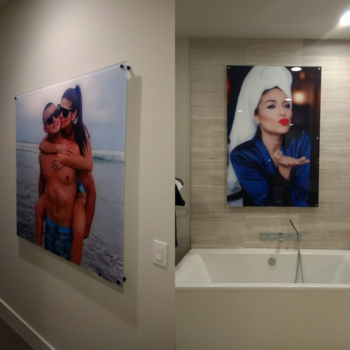Two indoor signs of enlarged images featuring a man and woman at the beach and a woman blowing a kiss 