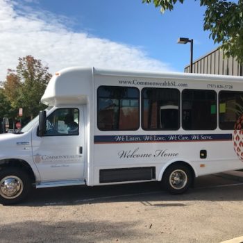 Commonwealth Senior Living transportation bus with logo graphics