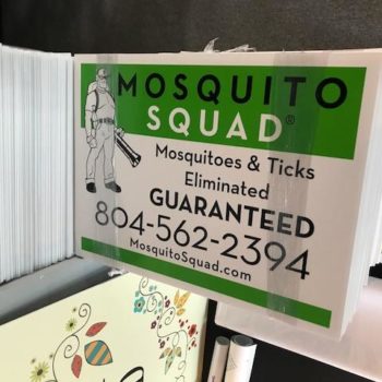 stacks of mosquito squad signs