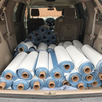 trunk of car filled with rolls of banners