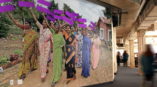 wall mural with image of woman in india holding up signs