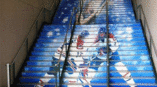 Floor graphics on staircase featuring hockey players and musical singer