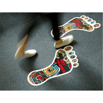 Floor graphics featuring two colorful patterned footprints and a person walking near them