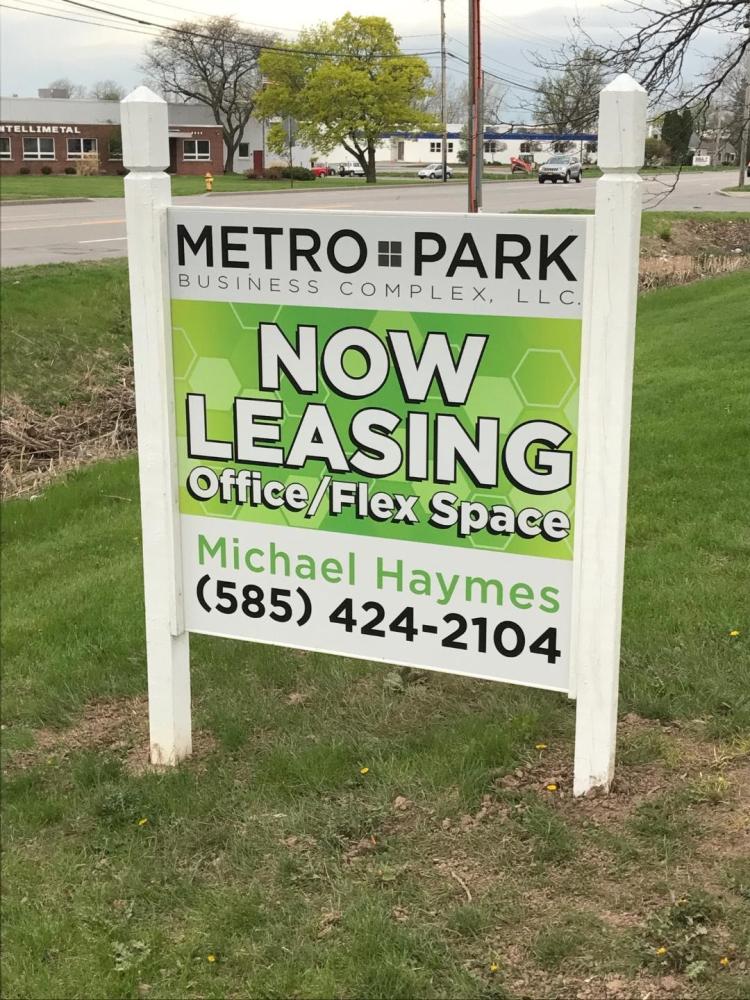 Metro park business complex now leasing outdoor sign with contact and phone number