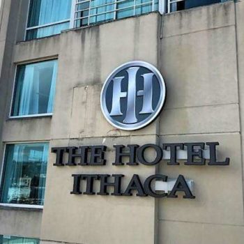 Outdoor signage on hotel for the hotel ithaca with silver and black logo