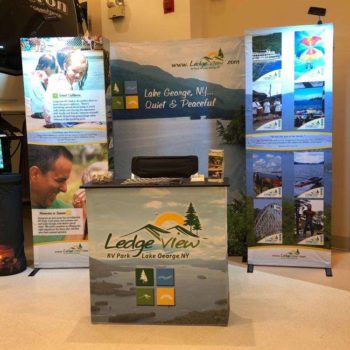 Ledge view rv park informational marketing display with pictures of lake george and activities