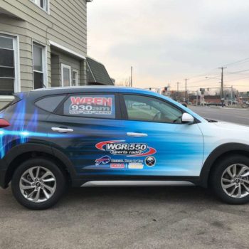 Blue vehicle wrap for WGR 550 sports radio blue and white design