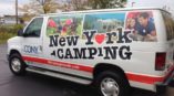 New york camping vehicle wrap with camping pictures and red line with website name