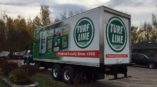 Turf line fleet wrap with product images and red box with phrase produced locally since 1956