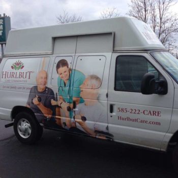 Hurlbut care communities vehicle wrap with two residents lifting weights smiling at a nurse