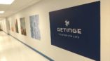Square decals on hallway wall with phrase getinge passion for life
