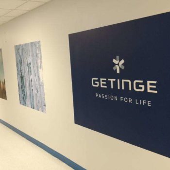 Square decals on hallway wall with phrase getinge passion for life