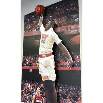 3D wall mural of basketball players in full arena with one jumping off the wall to shoot a basket