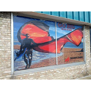 Window graphics with image of windsurfer on the beach and phrase go big or go home