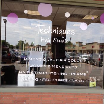 Techniques hair studio window graphics with services listed