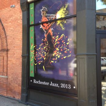 Rochester Jass, 2013 window signage with person playing an instrument