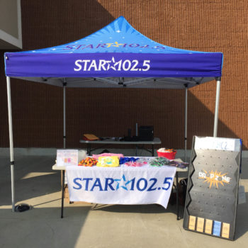Star 102.5 event tent with drop zone game and prizes