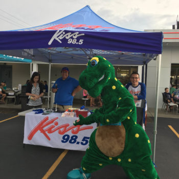 Kiss 98.5 event tent with dinosaur mascot