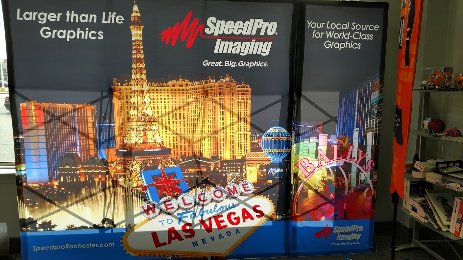 Speedpro imaging trade show display with las vegas background and welcome to las vegas sign