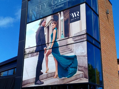 City Grill East Avenue window signage with woman and man posing