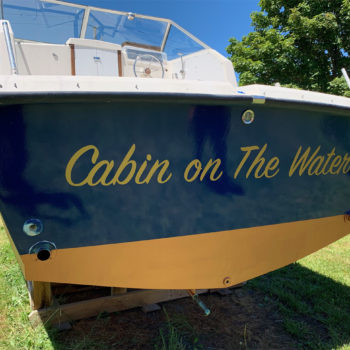 Vehicle wrap for boat with cabin on the water graphic