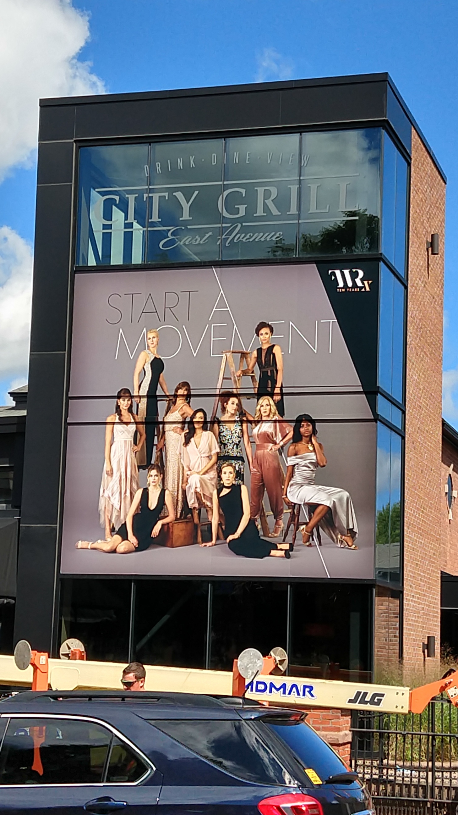 City Grill East Avenue window signage with group of women posing