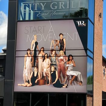 City Grill East Avenue window signage with group of women posing