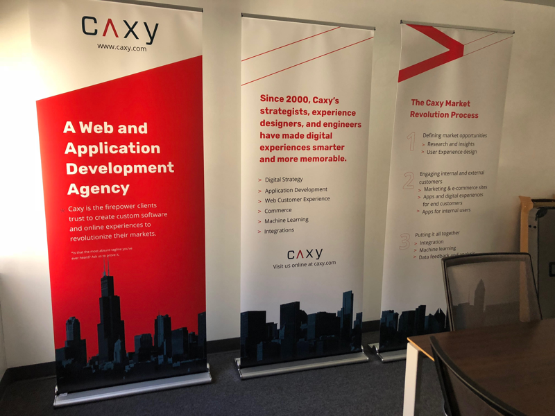 Three CAXY retractable banners