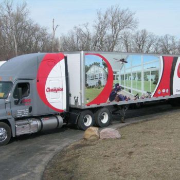 Eighteen-wheeler wrapped with graphics for the company Champion. 