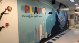 Hallway graphic in school encouraging play 