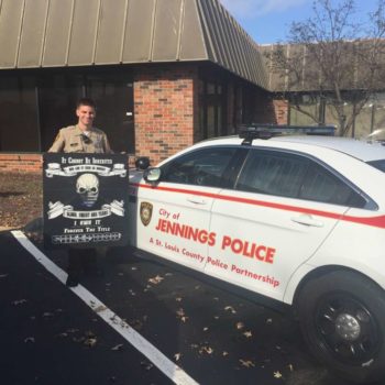 Jennings Police officer holding custom signage