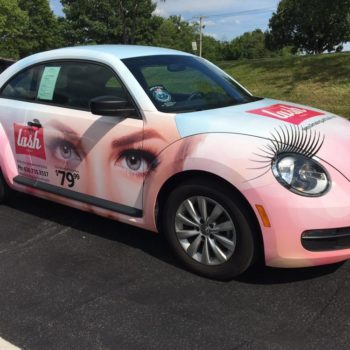 Custom pink vehicle wrap with lashes