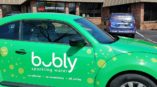 A car with a custom designed vehicle wrap for bubly sparkling water.