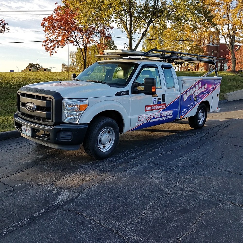 A pickup truck with a custom designed vehicle wrap for a garage door company.