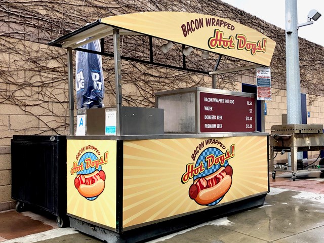 Fast food restaurant hot dog stand with vibrant advertising