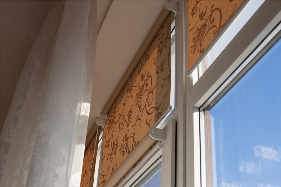 Stylish window treatment: curtain and brown shade enhancing interior design.