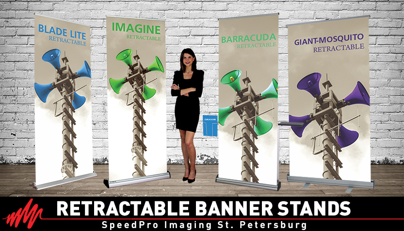 woman standing in front of four different retractable banner stands