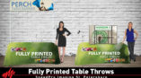 two women standing in front of fully printed table throws