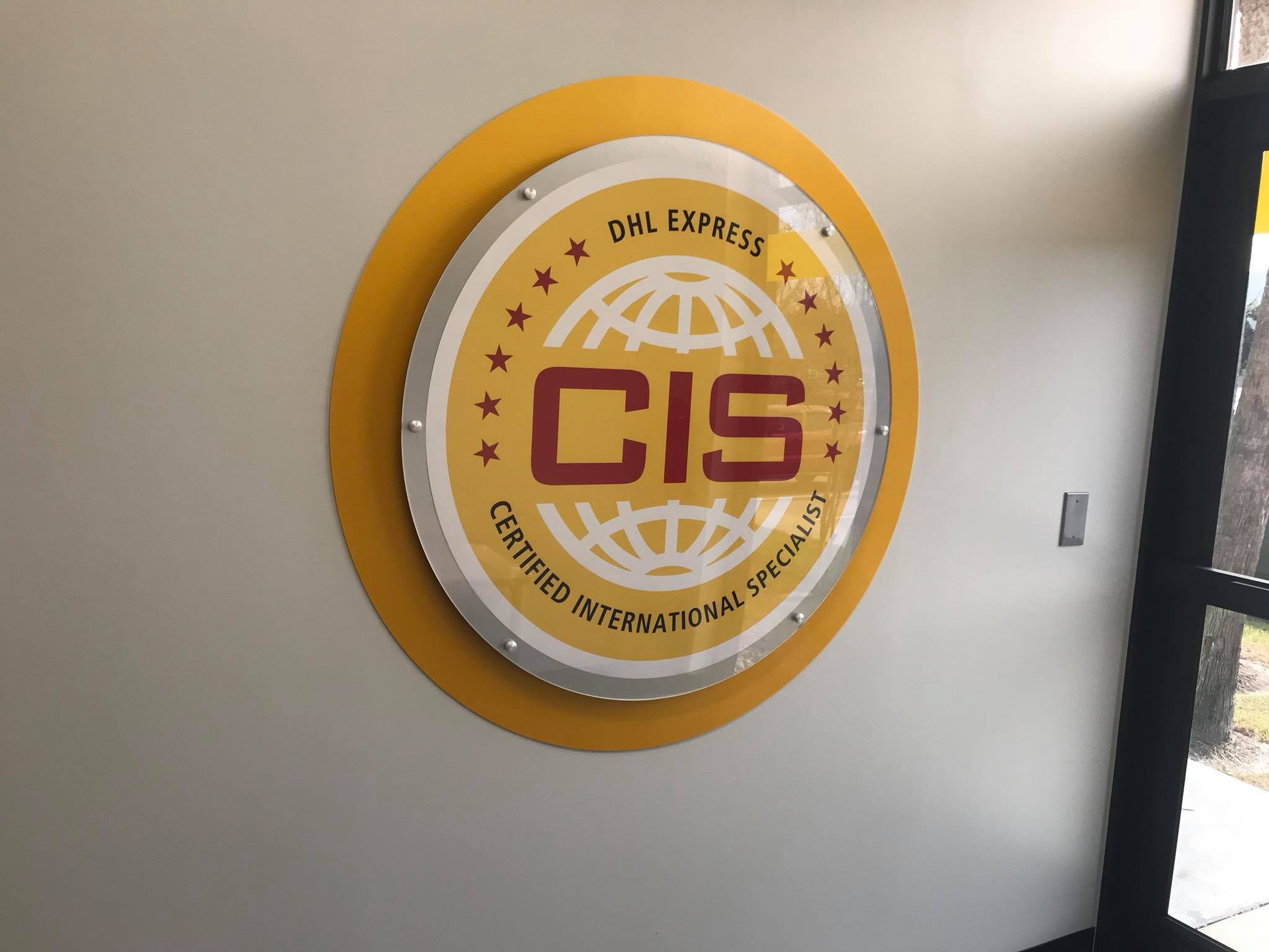 circular corporate indoor sign for DHL Express CIS