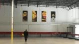 inside large warehouse with 4 canvas banners hanging on the wall